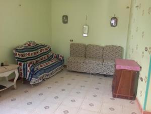 a living room with a couch and a table at Large and cheerful home with 2 floors in Fayoum Center