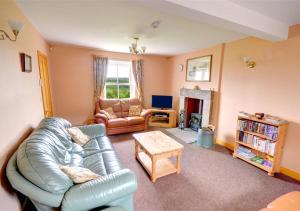 a living room with a couch and a table at Hole In The Ellers in Lealholm