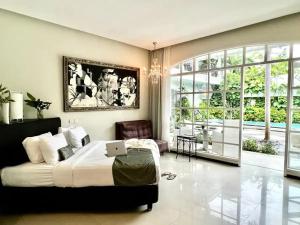 a bedroom with a bed with a laptop on it at Casa Artista By Kresna Hospitality in Seminyak