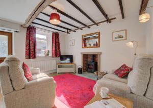 a living room with two couches and a red rug at Hillyard in Hawes