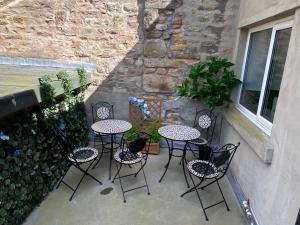 a patio with tables and chairs and a plant at Spacious City Centre Property in Lancaster