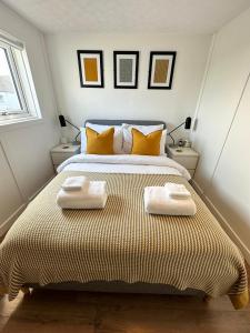 a bedroom with a bed with two towels on it at Peninsula Cottage in Garrabost