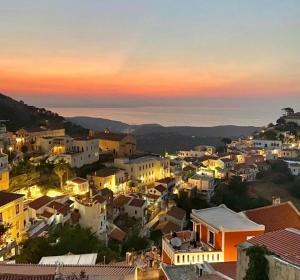 a view of a town at sunset with houses at Lion House I in Ioulis
