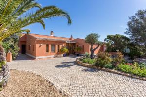 una casa con una palmera y un camino de entrada en Quinta Tannamara villa private pool & garden, en Burgau