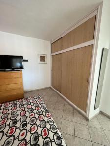 a room with a bed and a sliding door at Bungalow Cañaveras Vistas in Los Realejos