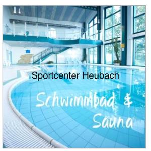 a swimming pool in a building with the wordsspector hospital sigmomedamed at Ferienwohnung Beer in Fehrenbach