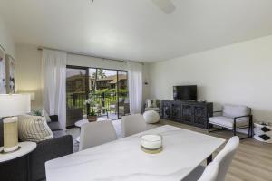 a living room with a white table and chairs at Pono Kai H204 condo in Kapaa