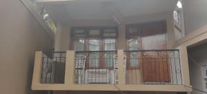 a balcony with a gate and doors on a building at Sahaki Homestay in Shillong