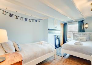 a bedroom with two beds and a table at Hillside in Robin Hood's Bay