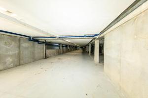 an empty hallway in an empty building with a white ceiling at Residence San Francesco in Tirrenia