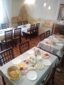 uma sala de jantar com duas mesas com pratos de comida em Iwonka Tylicz Pokoje i Apartamenty em Tylicz