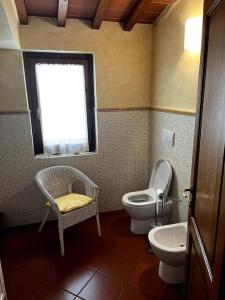a bathroom with a toilet and a sink and a window at Charming Townhouse with Garden in Impruneta