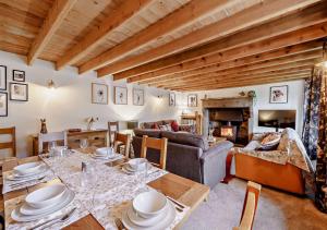 a living room with a table and a couch at High Green Cottage in Low Eskcleth