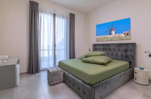 a bedroom with a bed and a large window at Casa B, Room 5 - Palm Kite Paradise in Marsala