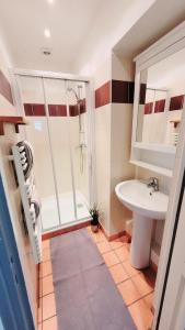 a bathroom with a shower and a sink at Le Cyrano - Versailles in Versailles