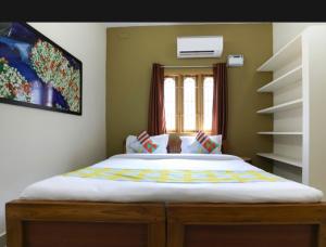 a bedroom with a large bed in a room at Bv Stayz in Chennai