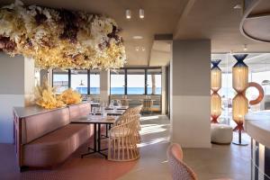 a dining room with a table and chairs at Akquaaa Boutique Hotel in Calafell