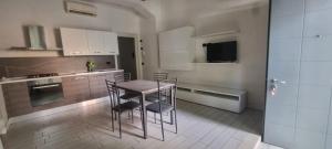 cocina con mesa y sillas en una habitación en Casa Adriana, en Piacenza