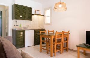 una cucina e una sala da pranzo con tavolo e sedie di Grupoandria Aparthotel Club Andria a Cala Santandria