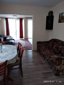 ein Wohnzimmer mit einem Sofa und einem Tisch in der Unterkunft Деспина in Baltschik