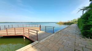 a wooden bridge over a body of water at KYA Luxury in Mamaia +11 photos