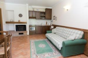 a living room with a couch and a kitchen at Borgo Caiano Country Inn in Caiano