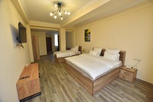 Ένα ή περισσότερα κρεβάτια σε δωμάτιο στο Altunyan Hotel