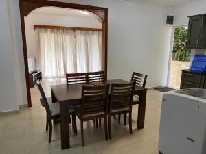 a dining room table and chairs in a kitchen at Blue bay in Blue Bay