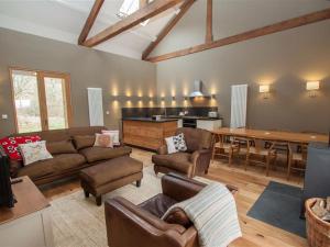 a living room with a couch and a dining room at Sunny Brow Hayloft in Ambleside