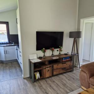 a living room with a flat screen tv on a wall at Ferienhaus Elbdiek in Bachenbrock