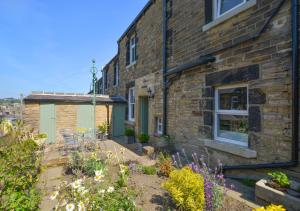 a brick house with a garden in front of it at Green Gable in Skipton