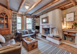 a living room with a couch and a fireplace at Green Cottage in Robin Hood's Bay