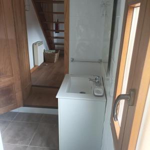 a bathroom with a white sink and a mirror at La Panera del Mejicano in Trevías