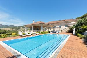a swimming pool in front of a house at Luxury Seaview Villa by Olala Homes in Teià