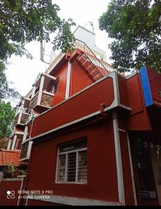 a red building with stairs on top of it at Shahi Residency in Panhāla
