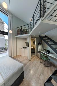 a bedroom with a bed and a staircase with a desk at BED in Athens in Athens