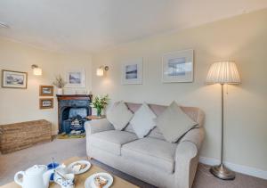 a living room with a couch and a fireplace at Flat 4 Whitehaven in Sandsend