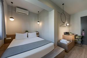 a bedroom with a large white bed and a desk at BED in Athens in Athens