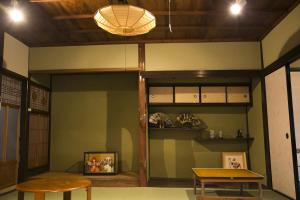 a room with shelves and a table and a table at Female-Only Guesthouse Tomari-ya in Tondabayashi