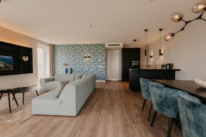 a living room with a couch and a table at Residence Oude Haven Colijnsplaat appartementen met verdieping in Colijnsplaat