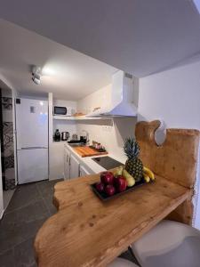 a kitchen with a wooden counter with fruit on it at Aquamarine in Firopótamos