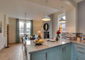 a kitchen with a island with a bowl of fruit on it at Fellside in Kettlewell