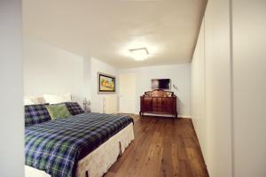 a bedroom with a bed and a dresser in it at La Cuntana Design Home in Potenza