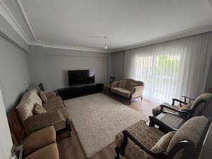 a living room with couches and a flat screen tv at an apartment in a decent neighborhood in Karşıyaka
