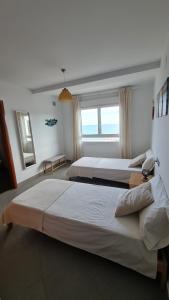 a bedroom with two beds and a window at Moraira Beach in Moraira