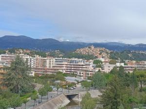 a city with buildings and mountains in the background at Provencal in Cagnes-sur-Mer