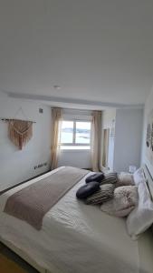 a large bed in a white room with a window at Moraira Beach in Moraira