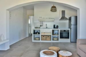 a living room with a couch and a kitchen at Relaxia Estate Naxos in Galini