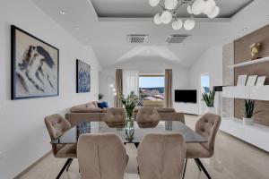 a living room with a dining room table and chairs at Apartment Star in Makarska