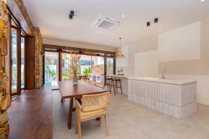 a kitchen and dining room with a table and chairs at Hoàng My Villa S7 in Vung Tau